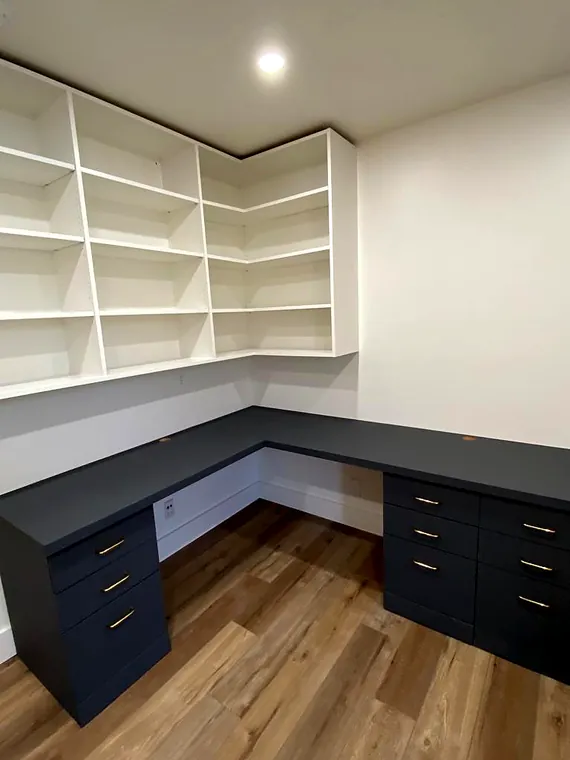 Finished built-in office shelving and dark lower cabinets