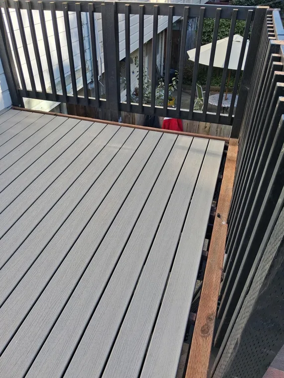 Gray deck landing boards enclosed by black railings