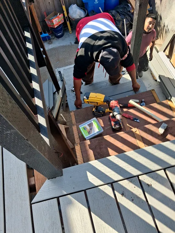 Carpenters installing boards on an exterior stair