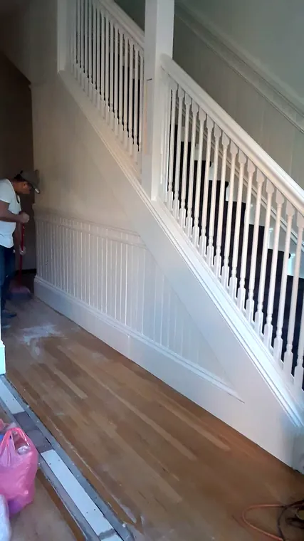 White interior stair railing and finished wood floor