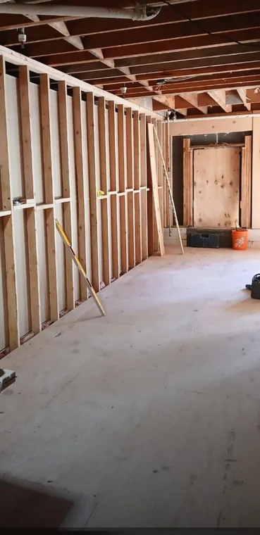 Interior renovation with exposed wall and ceiling framing