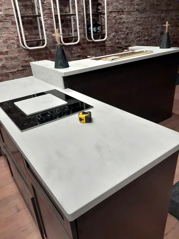 Stone countertop and cooktop installed in a remodeled kitchen