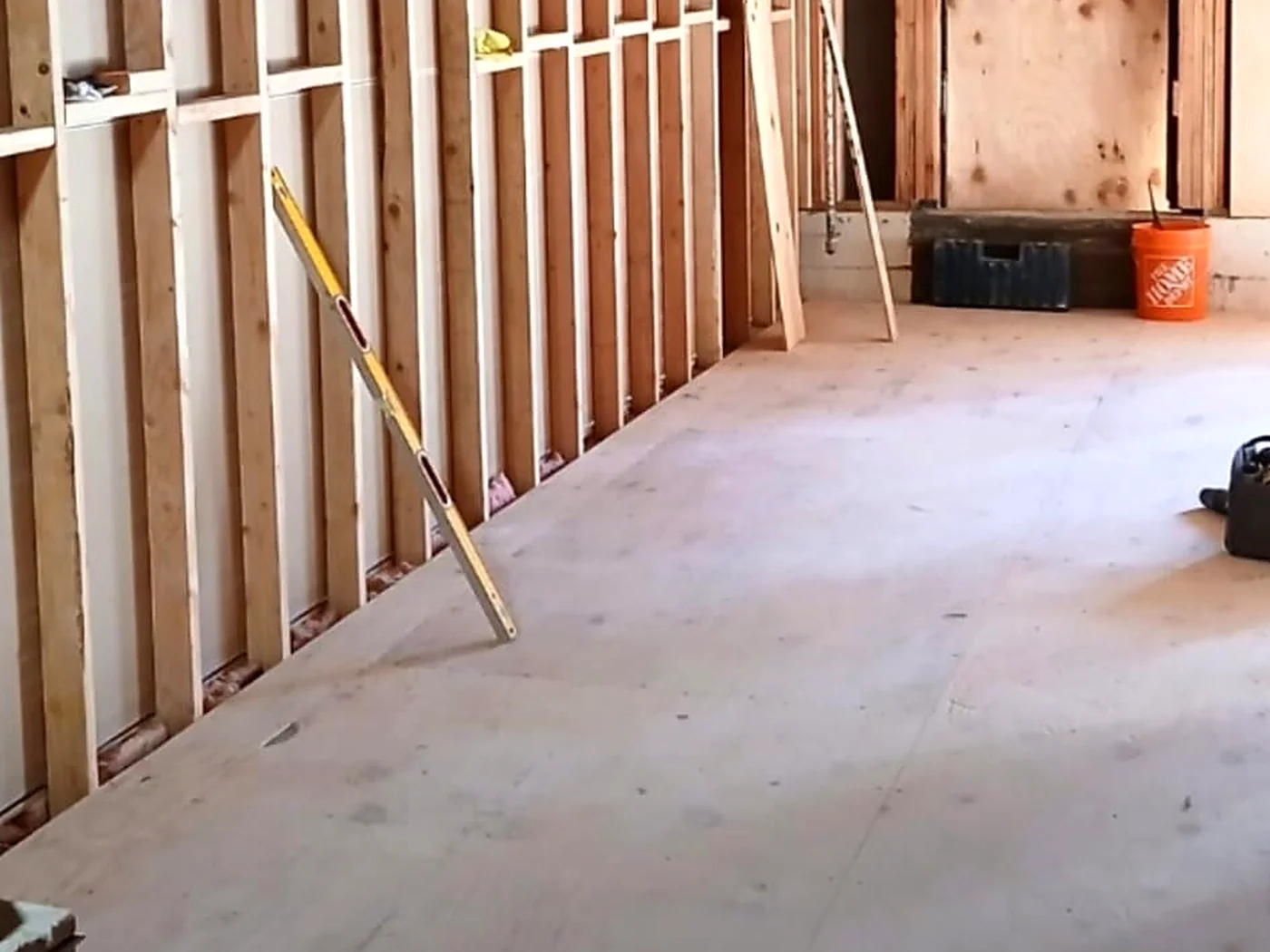 Interior room with exposed wood wall and ceiling framing
